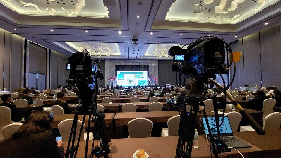 กล้องวิดีโอสองตัวบนขาตั้งถ่ายทอดงานประชุมในห้องจัดเลี้ยง